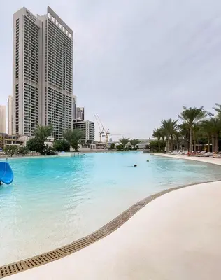 a swimming pool in the middle of a city with tall buildings at Luxury apartments at Vida Residences in Dubai
