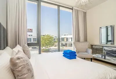 a bedroom with a white bed and a large window at New Arabian Dubai Hills villa- 3 BR & Maid Golf Grove With Private pool in Dubai