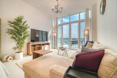 a living room with a couch and a tv at Studio in Palm Views West at Palm Jumeirah by PK Holidays in Dubai
