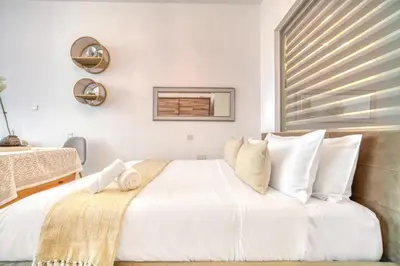 a bedroom with a large white bed with white pillows at Studio in Palm Views West at Palm Jumeirah by PK Holidays in Dubai