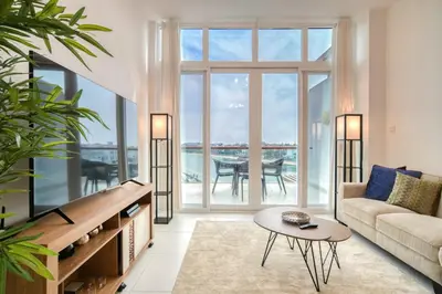 a living room with a couch and a table at Studio in Palm Views West at Palm Jumeirah by PK Holidays in Dubai