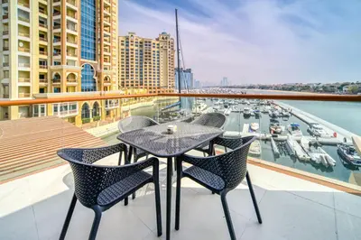 a table and chairs on a balcony with a marina at Studio in Palm Views West at Palm Jumeirah by PK Holidays in Dubai