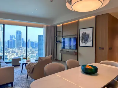 a living room with a table and chairs at Address Residence Dubai Opera 21 by Luxstay Holiday Homes in Dubai