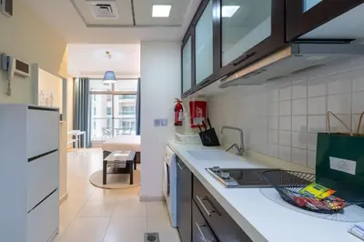 a kitchen with a sink and a stove at Very nice studio in Skyview Tower Dubai Marina in Dubai