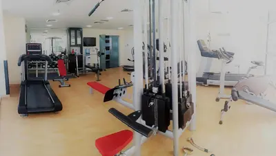 a gym with treadmills and machines in a room at Very nice studio in Skyview Tower Dubai Marina in Dubai