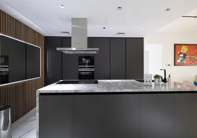 a kitchen with black cabinets and a kitchen island at Palm Jumeirah Paradise- Luxury,Unveiled in Dubai