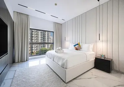 a bedroom with a large bed and a large window at Palm Jumeirah Paradise- Luxury,Unveiled in Dubai