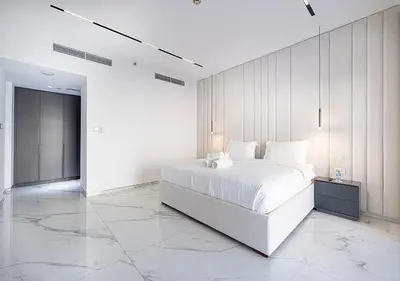 a white bedroom with a large bed and a large marble floor at Palm Jumeirah Paradise- Luxury,Unveiled in Dubai