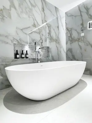 a white sink in a bathroom with a marble wall at Palm Jumeirah Paradise- Luxury,Unveiled in Dubai