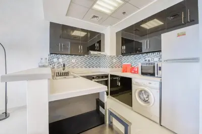 a kitchen with a sink and a dishwasher at Spacious 1BR in Botanica tower with sea view by PK holidays in Dubai