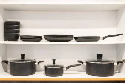 a row of pots and pans on a stove at Modern Studio Lake View JLT Near Marina & Metro in Dubai