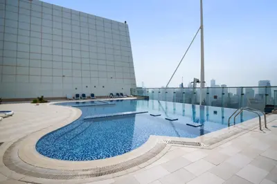 a swimming pool on the roof of a building at Modern Studio Lake View JLT Near Marina & Metro in Dubai