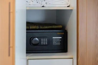 a microwave in a closet with towels on a shelf at Modern Studio Lake View JLT Near Marina & Metro in Dubai