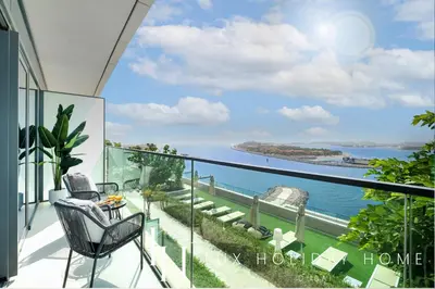 a balcony with a view of the ocean at LUX The Beachfront Island View Suite in Dubai