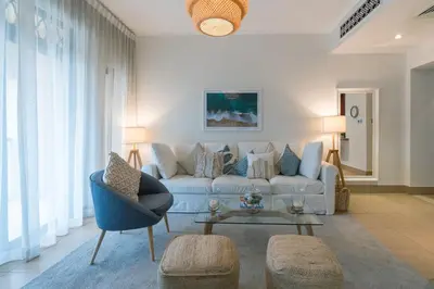 a living room with a couch and a table at Spacious 2Bedroom with Burj View in Downtown Dubai in Dubai