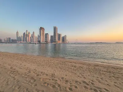 a sandy beach with a city in the background at Frank Porter - Seven Hotel & Aprtments in Dubai