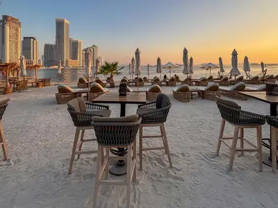 a group of tables and chairs on the beach at Frank Porter - Seven Hotel & Aprtments in Dubai