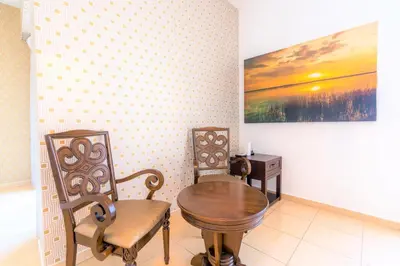 a dining room with two chairs and a wooden table at Stunning Beach front Apt Dubai Eye View JBR Dubai in Dubai