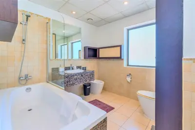 a bathroom with a tub and a toilet and a sink at Stunning Beach front Apt Dubai Eye View JBR Dubai in Dubai