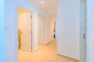 a hallway with white doors and a tile floor at Stunning Beach front Apt Dubai Eye View JBR Dubai in Dubai