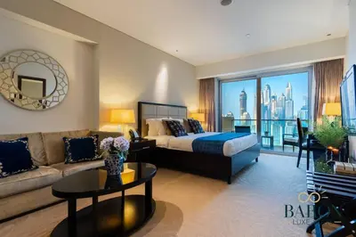 a large bedroom with a bed and a couch at The Refined in Dubai