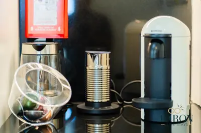 a coffee maker and a blender on a counter at The Refined in Dubai