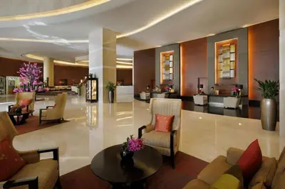 a lobby of a hotel with chairs and a table at The Urban in Dubai