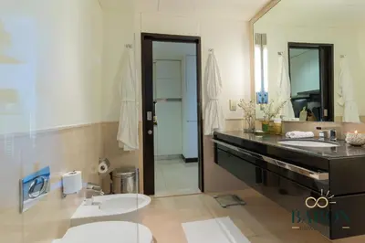 a bathroom with two sinks and a large mirror at The Urban in Dubai