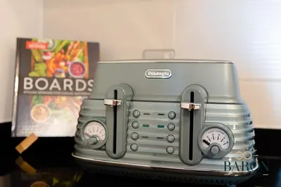 a toaster is sitting on top of a table at The Grand Palm Suite Oceana in Dubai