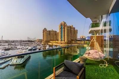 a balcony with a view of a marina with boats at The Grand Palm Suite Oceana in Dubai
