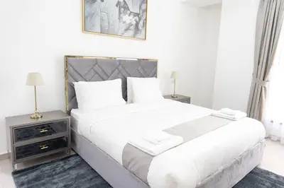 a bedroom with a large white bed with two night stands at Shams Beach Front JBR apartments by HAPPY SEASON in Dubai