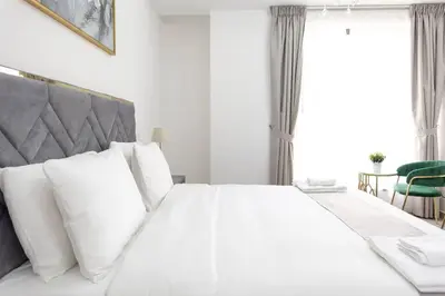 a bedroom with a large white bed with white pillows at Shams Beach Front JBR apartments by HAPPY SEASON in Dubai