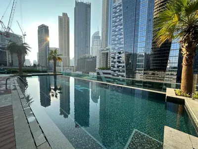 a swimming pool in a city with tall buildings at Lux BnB Upper Crest Tower I Skyline Views in Dubai