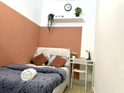 a small bedroom with a bed and a shelf at Luxurious Partition Room in Tecom Near Internet City Metro Station in Dubai