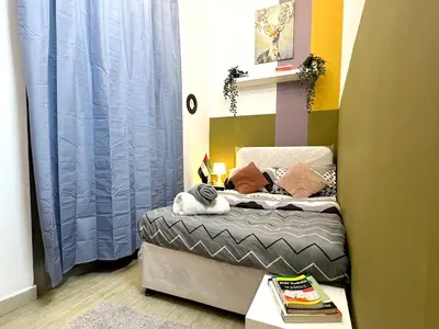 a small bedroom with a bed with blue curtains at Double window Partition Room in Tecom Near Metro in Dubai