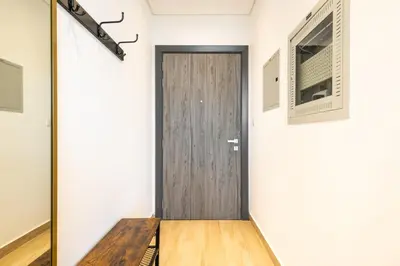 a hallway with a wooden door in a room at Daniels Cozy Studio at JVC in Dubai
