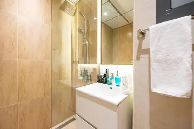 a bathroom with a sink and a shower at Daniels Cozy Studio at JVC in Dubai