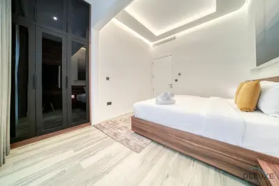 a bedroom with a white bed and a large window at Modern 1BR at Marina Park Dubai Marina by Deluxe Holiday Homes in Dubai