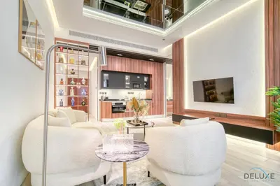 a living room with two white chairs and a table at Modern 1BR at Marina Park Dubai Marina by Deluxe Holiday Homes in Dubai