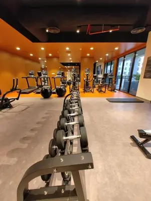 a gym with rows of exercise equipment in a room at Ultimate Stay Port de La Mer with Burj Khalifa Views from the Bed next to the Beach in Dubai