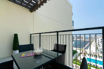 a balcony with a table and a view of the city at Ultimate Stay Port de La Mer with Burj Khalifa Views from the Bed next to the Beach in Dubai