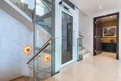 a glass staircase in a house with a hallway at Triplex Paradise Penthouse in Dubai