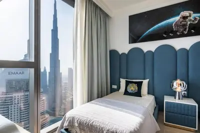 a bedroom with a bed and a view of a city at Triplex Paradise Penthouse in Dubai