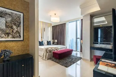 a hotel room with a bed and a large window at Triplex Paradise Penthouse in Dubai