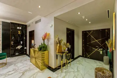 a living room with a marble floor and a gold console at Triplex Paradise Penthouse in Dubai