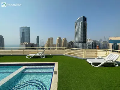a swimming pool on the roof of a building at Quiet Studio with Balcony and Roof Top Pool in Dubai Marina in Dubai