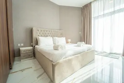 a bedroom with a large bed with two towels on it at AWS Holiday Homes - Luxurious 2BR in Business Bay in Dubai