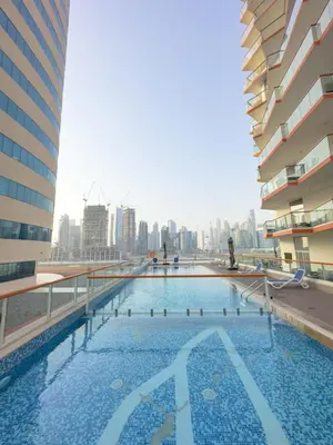a large swimming pool with a city skyline in the background at AWS Holiday Homes - Luxurious 2BR in Business Bay in Dubai