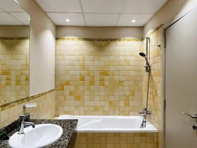 a bathroom with a bath tub and a sink at La buena vida holiday homes - Deluxe 3 bedroom apartment on the beach in Dubai