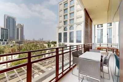 a balcony with a table and chairs and a view of the city at Sunset at Creek Beach - Exquisite Two Bedroom in Dubai